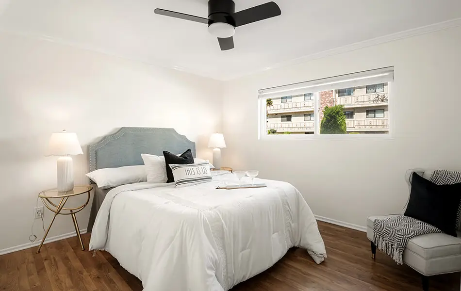 Bedroom front view with queen bed ceiling fan and hardwood floors at 11550 Nebraska Ave condo for sale