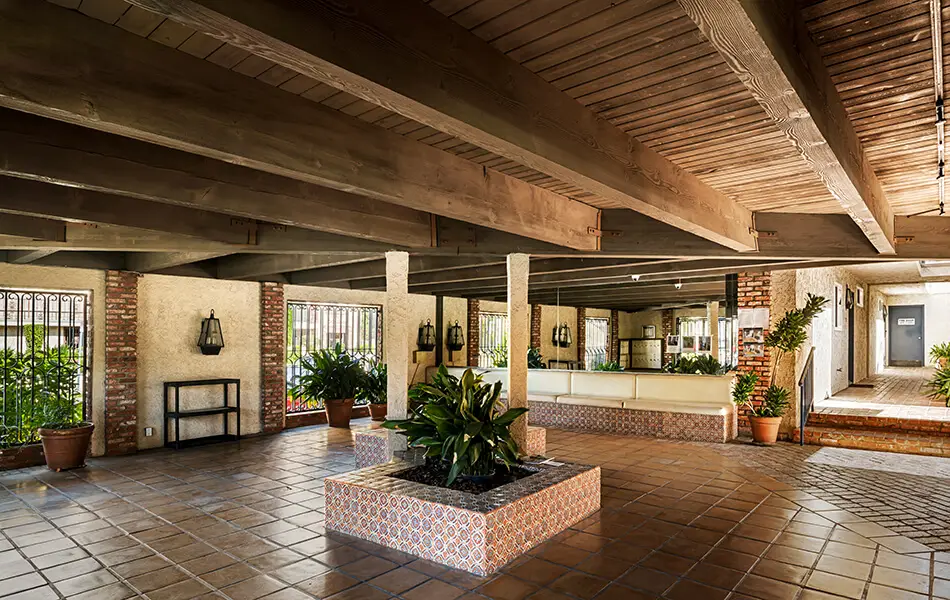 Courtyard lobby with wood beam ceiling and decorative tile at 11550 Nebraska Ave west LA condo building